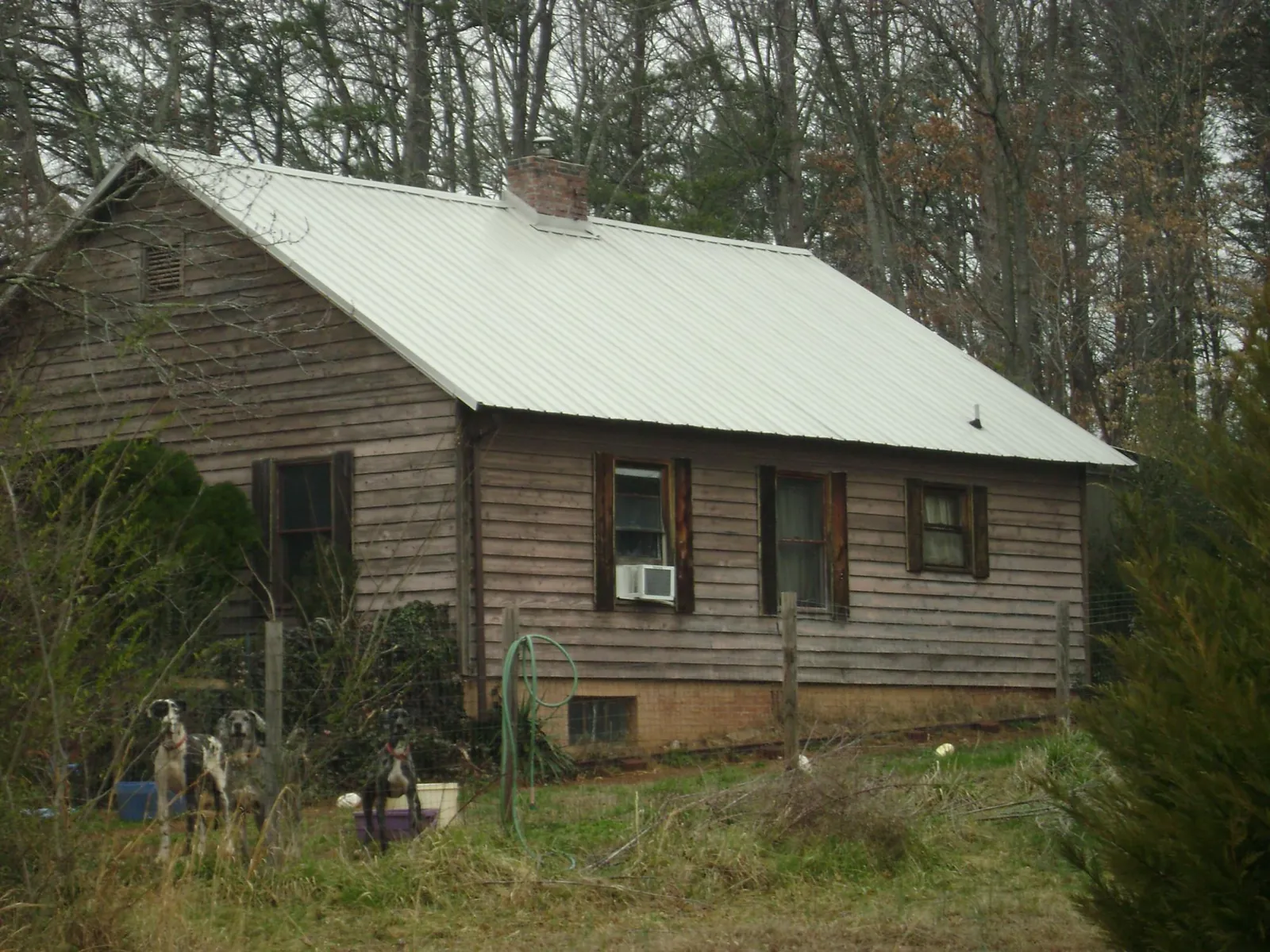White metal roof on an old wood sided farmhouse, from a Metal Roof Installation job in Donora